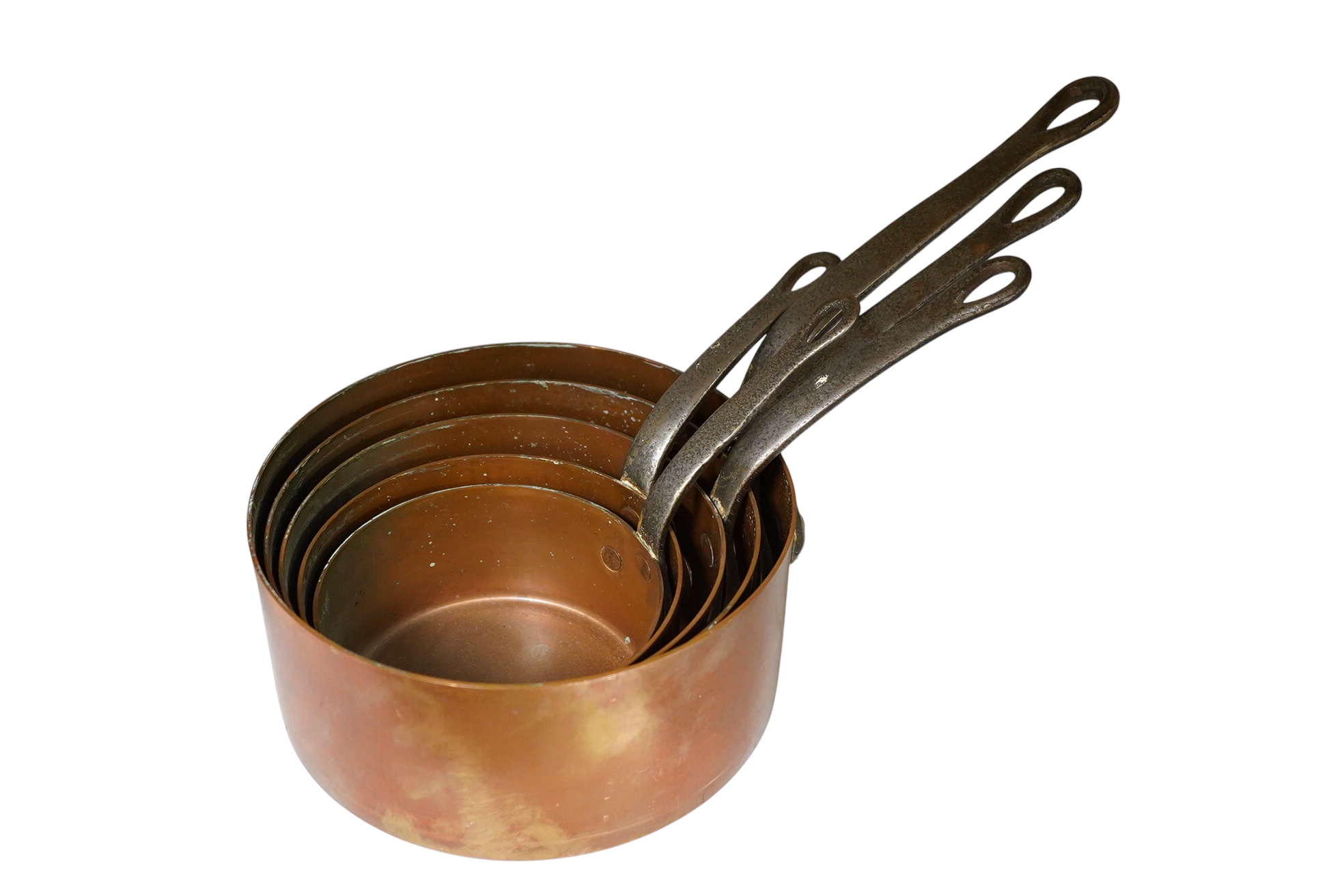 A graduated set of five copper saucepans